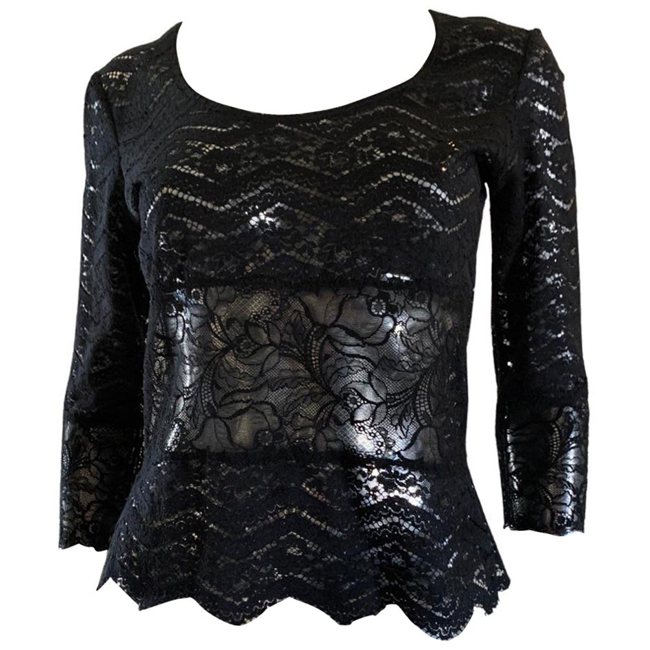 Christian Lacroix lace blouse is like a luxe, designer T-shirt that goes from daytime with jeans to cocktails with silk. The blouse has an engineered lace pattern with scalloped hem.  3/4 length sleeve. France size: 42. USA size: 10. 