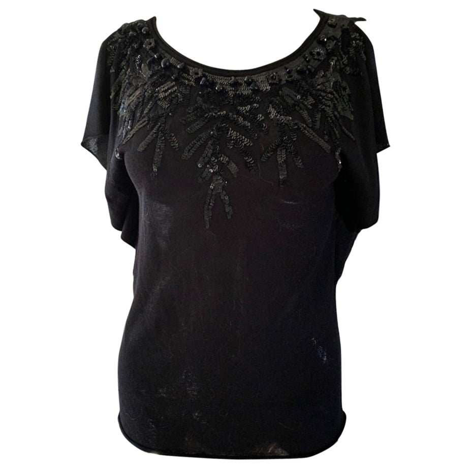 This blouse is so versatile and can go from day to evening. Designed for the Valentino Roma collection this very find net drapes like a European jersey made of viscose and cotton. The beating around the neck is quite beautiful and intricate with