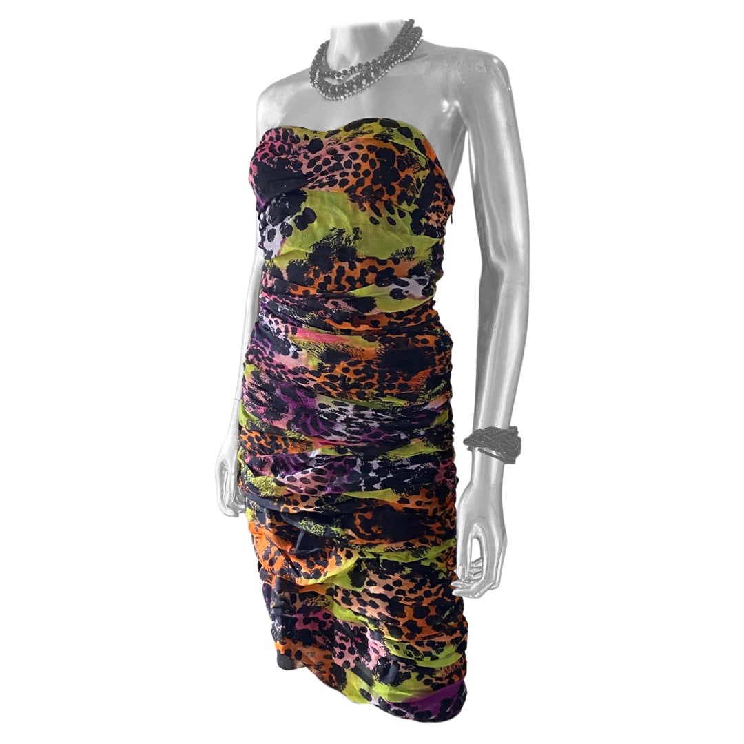 This sexy little party dress was designed by Diane von Furstenberg With a bright multicolor print that’s sold out worldwide called African Sugar. The bustiers dress is ruched silk chiffon. The black lining is silk and Lycra for a little stretch. New