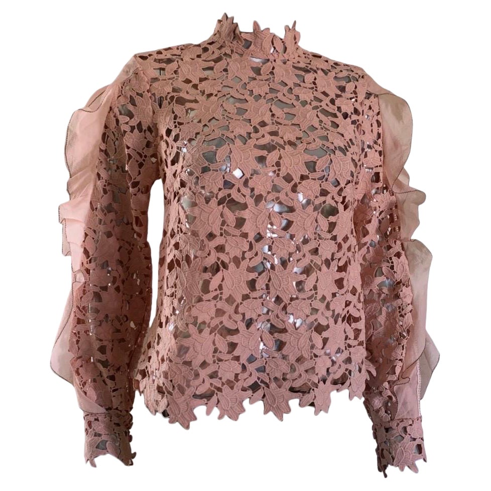 Self portrait is a very successful line based in the United Kingdom. The designer is known for making clothes that women feel feminine and fashionable in. This beautiful guipure lace blouse looks so chic on. The sleeves are beautiful. Ruffled