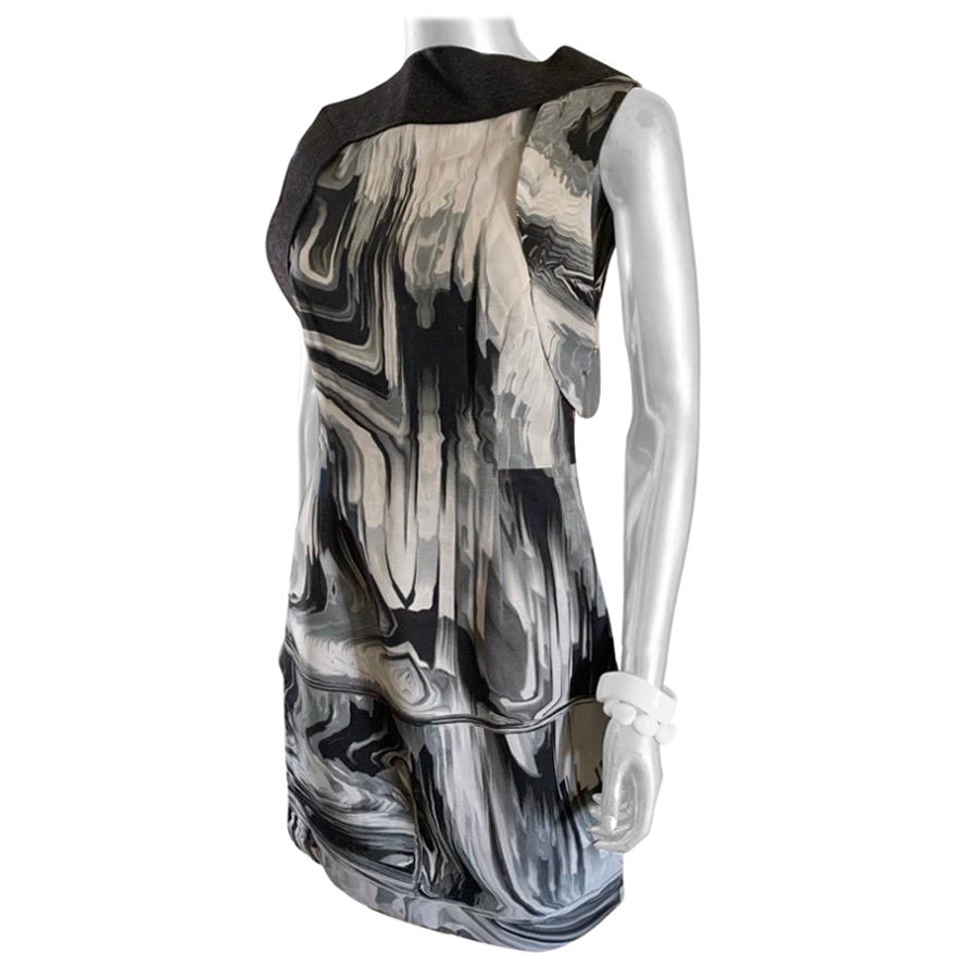 This print is so modern and so chic. A sleeveless sheath designed by Vera Wang is made in a beautiful rayon blend faille fabric. What makes the dress so modern is it has an asymmetrical collar detail in a trapunto wool angora band that starts at the