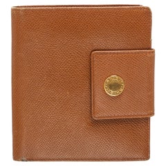 Brown leather Bvlgari compact wallet with gold-tone hardware, woven logo