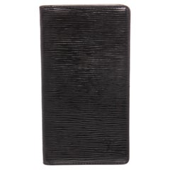 Black Epi leather Louis Vuitton Vertical wallet with debossed logo 