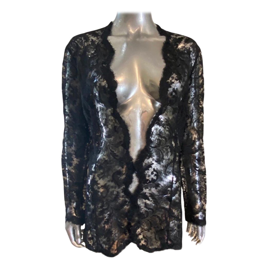A very simple and chic black lace cardigan jacket by designer Josie Natori. The jacket is made of European fine lace but it is perfectly cut with hidden seems to form a sexy modern fit. The jacket is shown closed with a pin for the photos to show