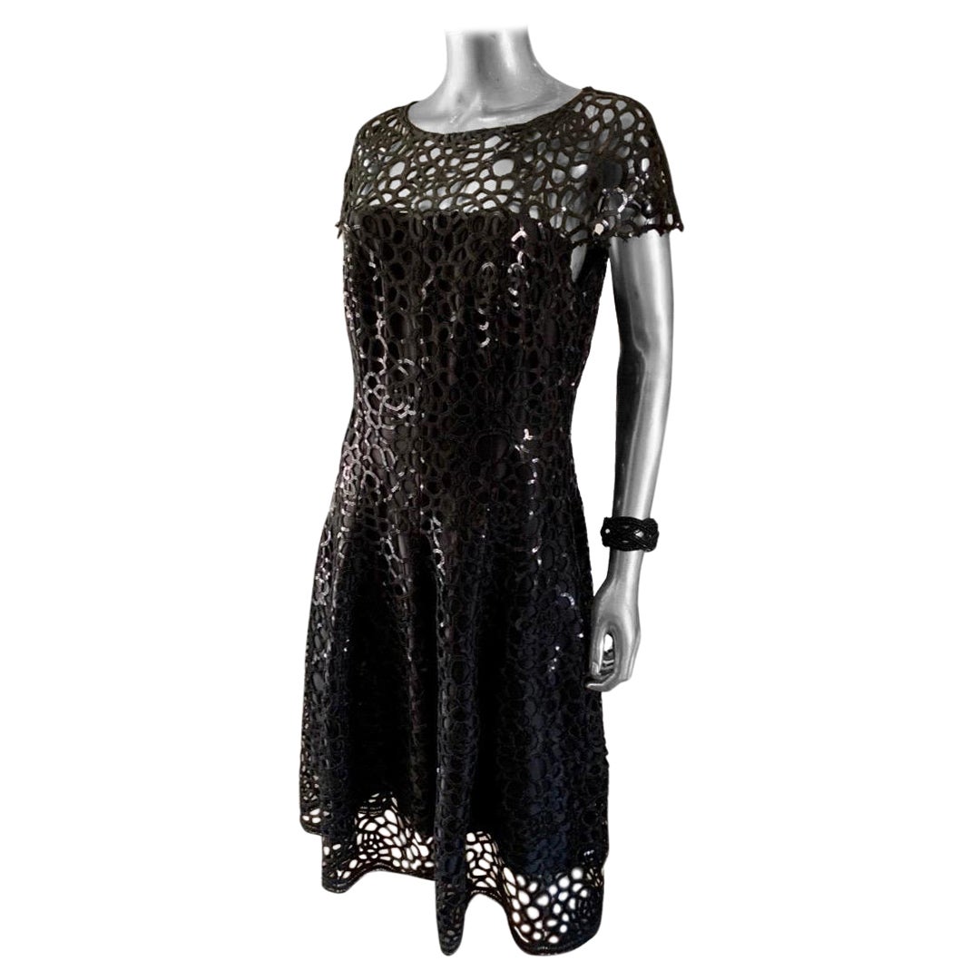 What is chic little black dress. This one happens to be celebrity owned and only worn once to a movie premiere event. Talbot Runhof is an extremely talented European designer. This dress is Made entirely of Guipure black lace. It has hand sewn