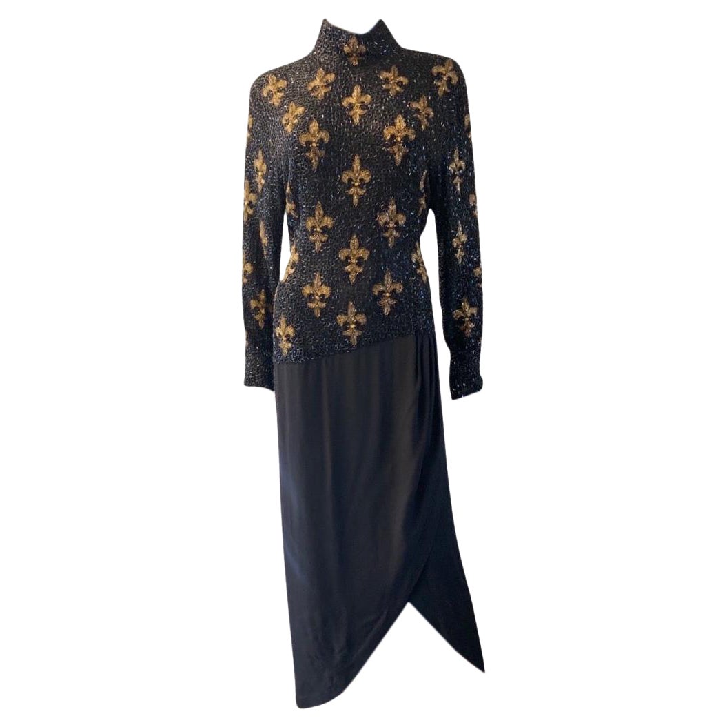 Such a beautiful vintage Bob Mackie Boutique dress. The fully bugle beaded silk  bodice has a gold fleur de lis pattern on the front and solid black beads on the back. The attached skirt has a wrap design in a heavy black crepe . Very flattering on.