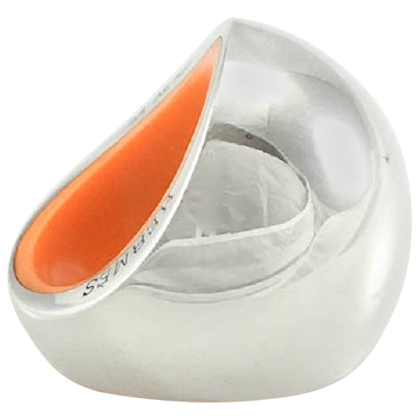 Hermes Silver Quark Ring. This gorgeous silver ring by Hermes is part of the Quark line. In solid silver, it has a great, smooth and round chunky design. The inside of the ring is made in hard plastic in Hermes iconic orange. It has just been