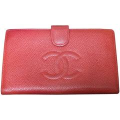 Vintage CHANEL red caviar leather wallet with large CC logo stitch mark. Classic