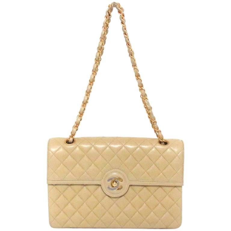 Vintage Chanel beige 2.55 classic flap bag with gold, silver CC. Paris Limited.