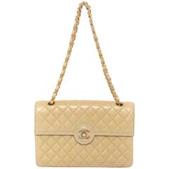 Vintage Chanel beige 2.55 classic flap bag with gold, silver CC. Paris Limited.