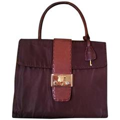 Retro Prada leather and nylon mix dark brown handbag with golden closure.