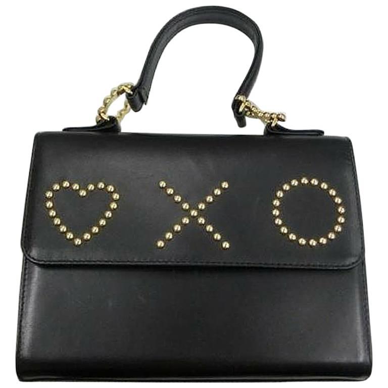 Vintage MOSCHINO black leather handbag in classic kelly purse style. Heart 
XO For Sale