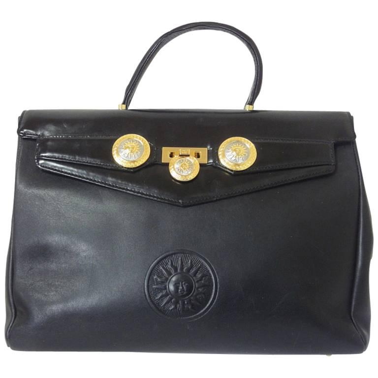 Vintage Gianni Versace genuine black leather Kelly style bag with Sunburst motif