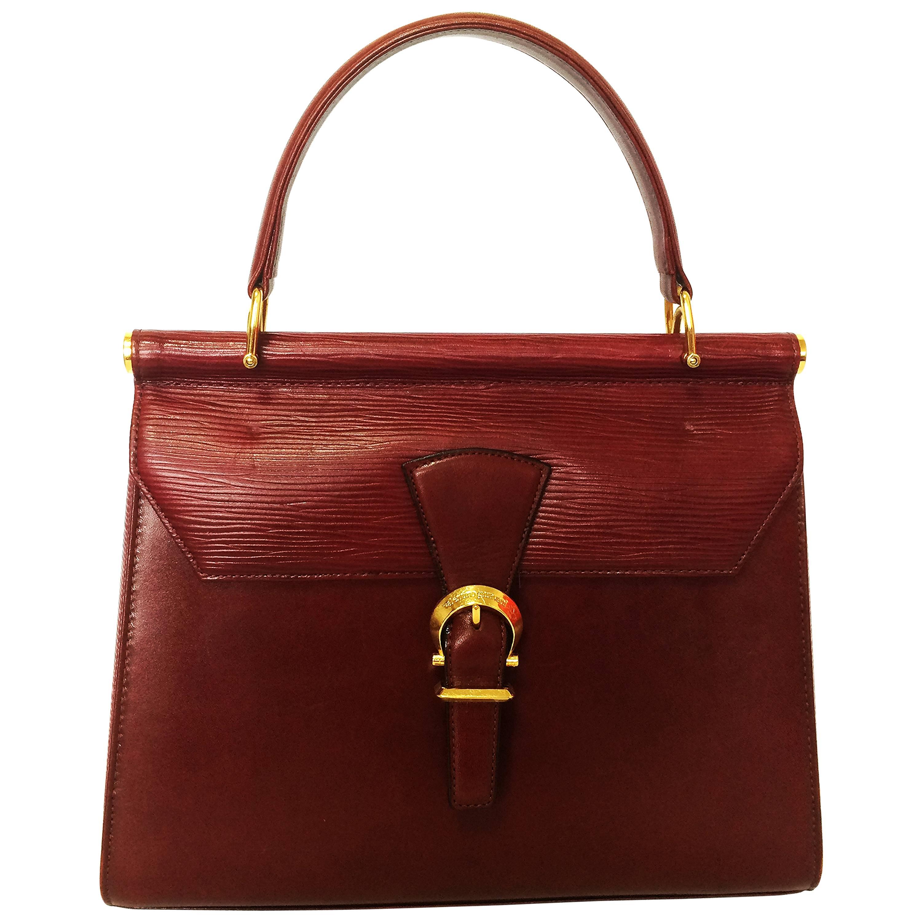 Vintage Valentino Garavani wine epi and smooth leather handbag with buckle flap.