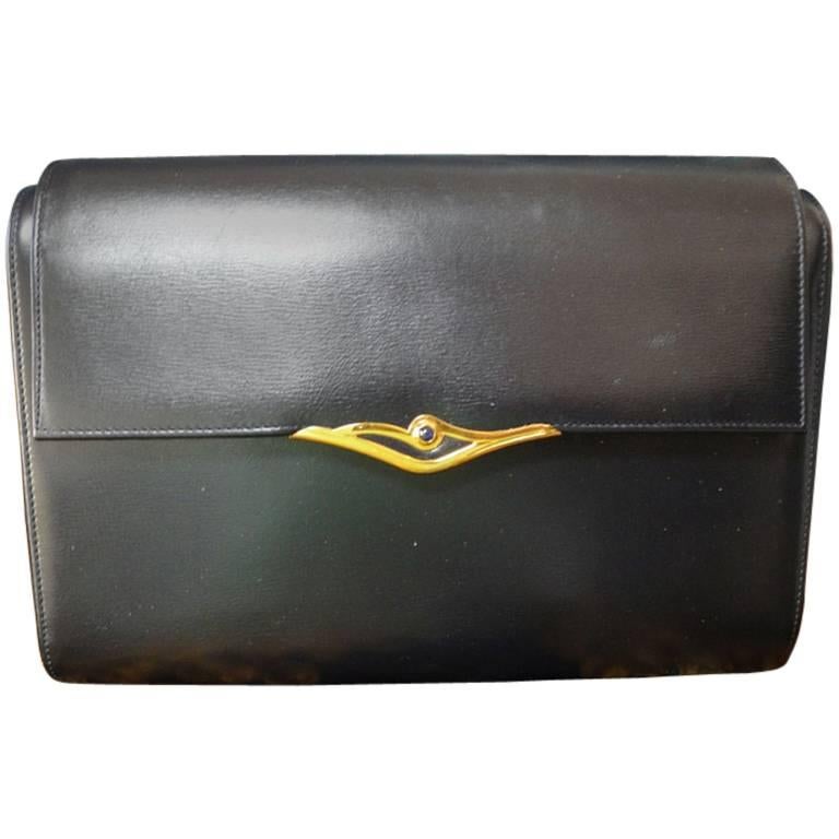 Vintage Cartier black navy  leather classic shape clutch bag with blue stone. For Sale