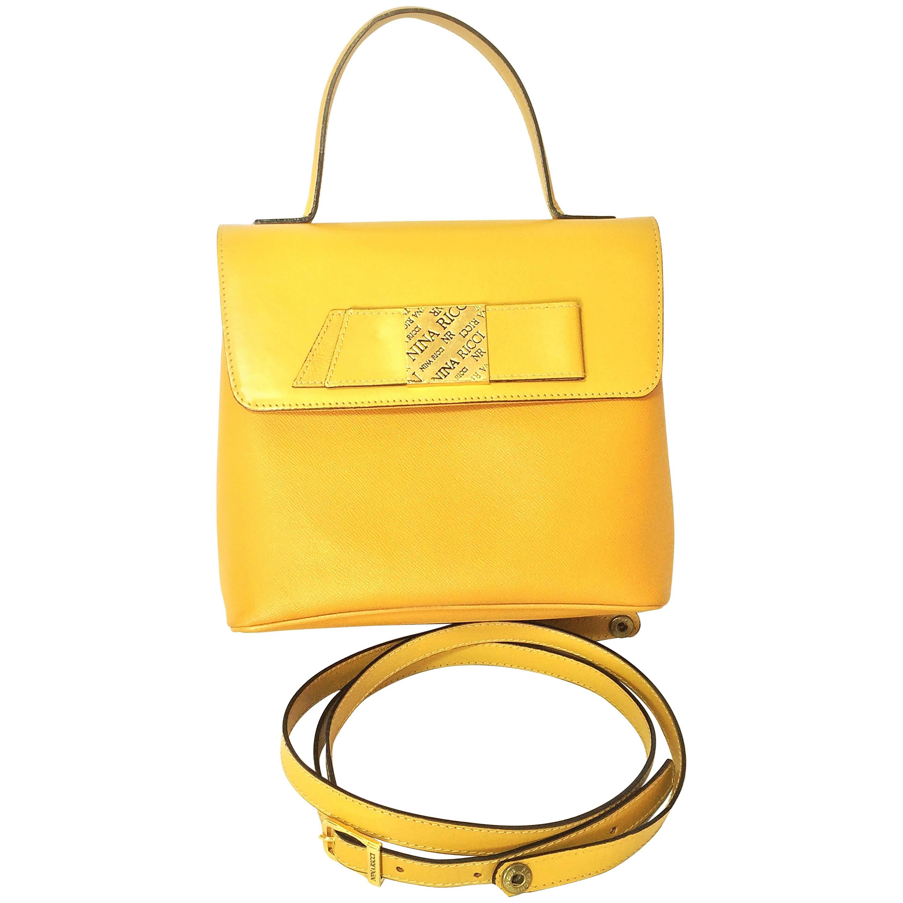 MINT. Vintage Nina Ricci yellow leather handbag purse with shoulder strap.