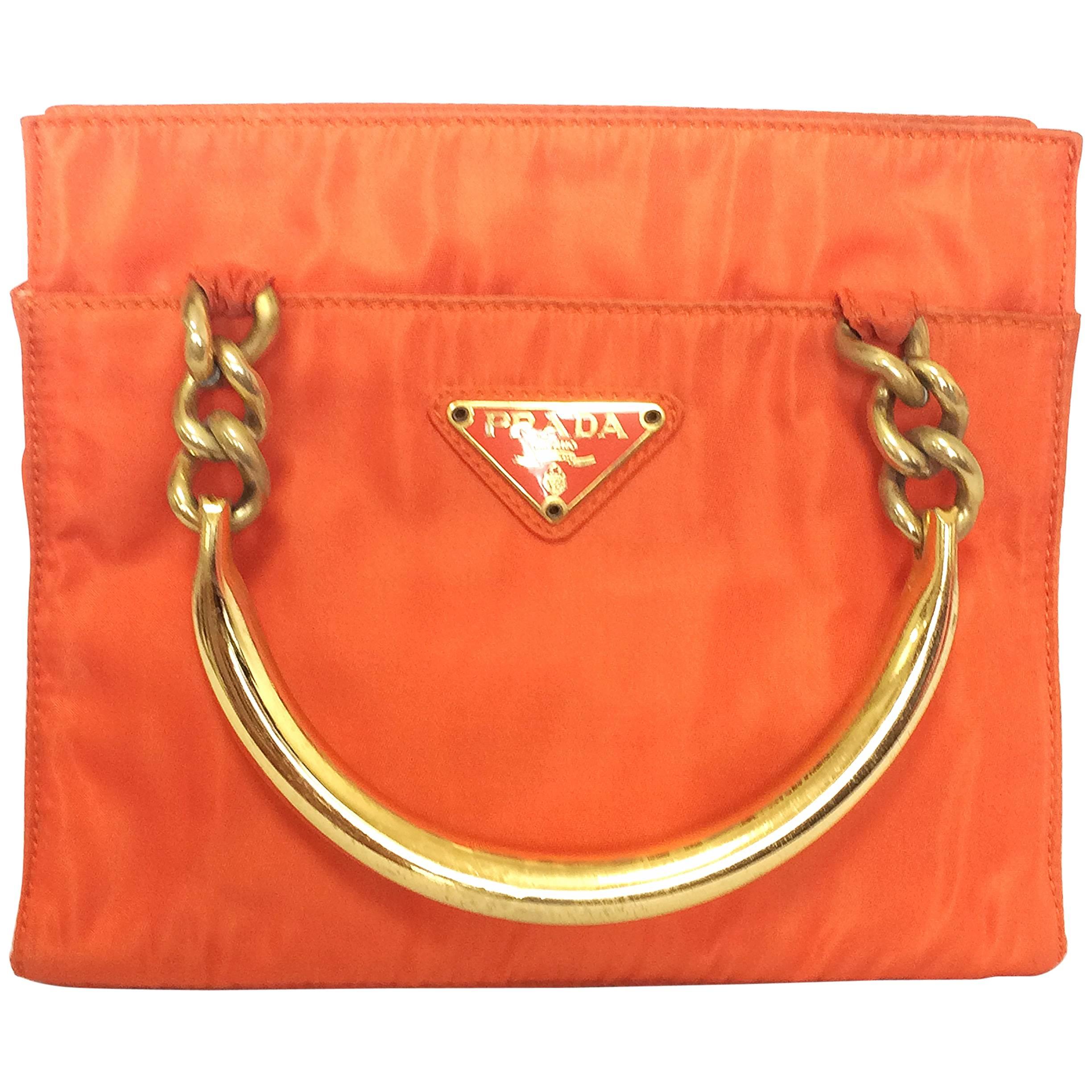 Vintage PRADA orange nylon mini tote bag with golden chain and metallic handles.