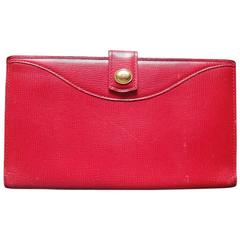 Retro Christian Dior red genuine leather wallet with gold tone CD charm.