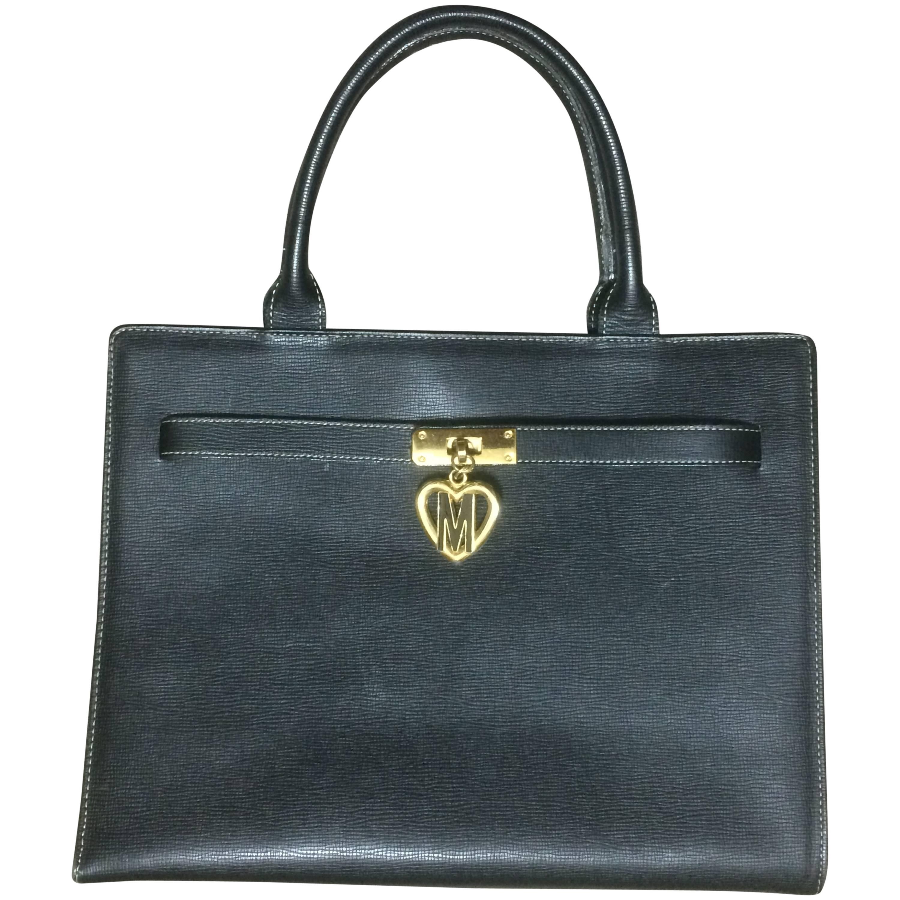 Vintage MOSCHINO black leather tote bag in Kelly purse style with iconic M charm For Sale