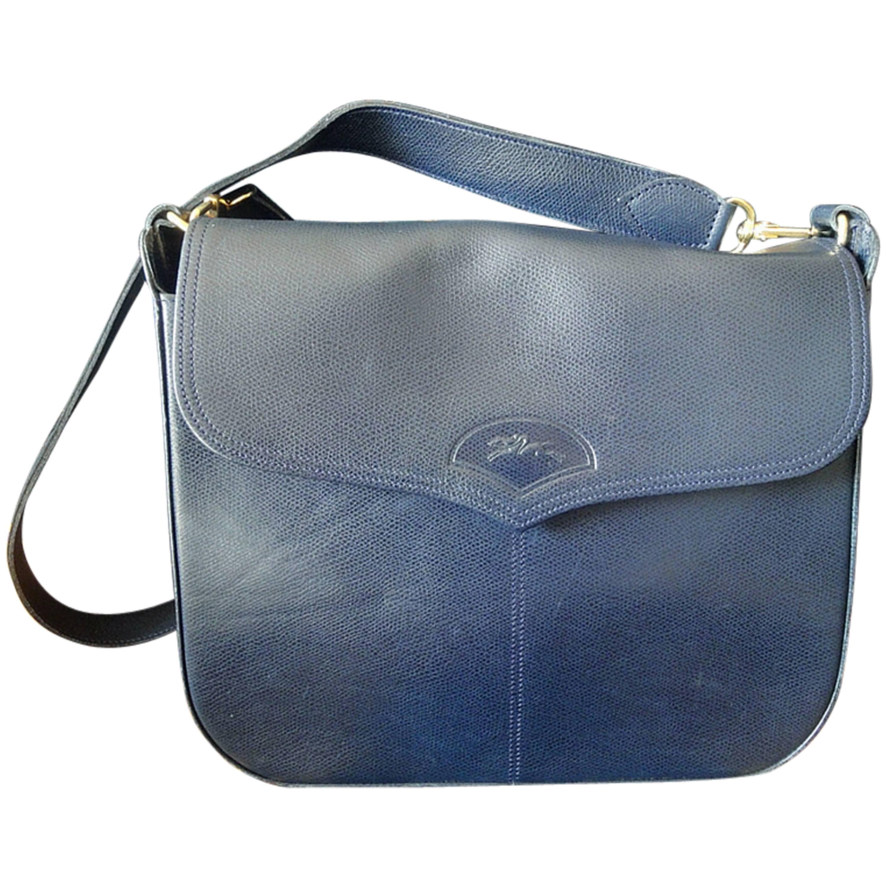 Vintage Longchamp navy leather shoulder bag with the embossed logo at front flap