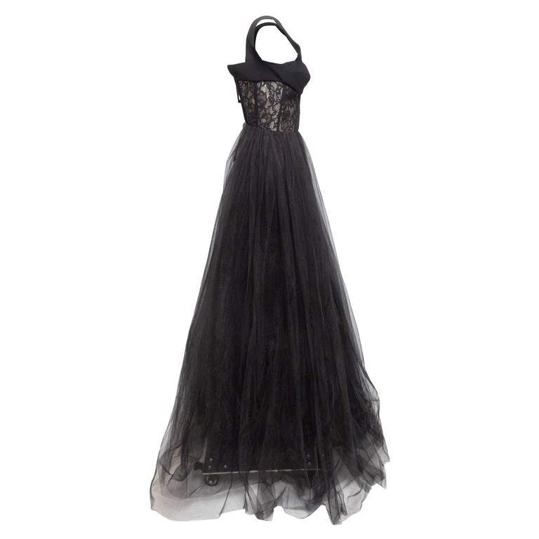 Product Details: Black lace and tulle sleeveless evening gown by Rasario. Sweetheart neckline. Zip closure at center back. 28