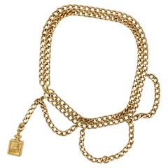 Vintage chain belt, draped with Chanel perfume bottle