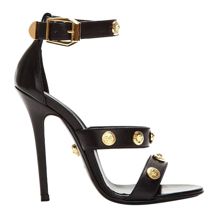 New Versace Signature Gold Tone Medusa Black Leather High Heel Sandals 37.5  7.5 For Sale at 1stDibs