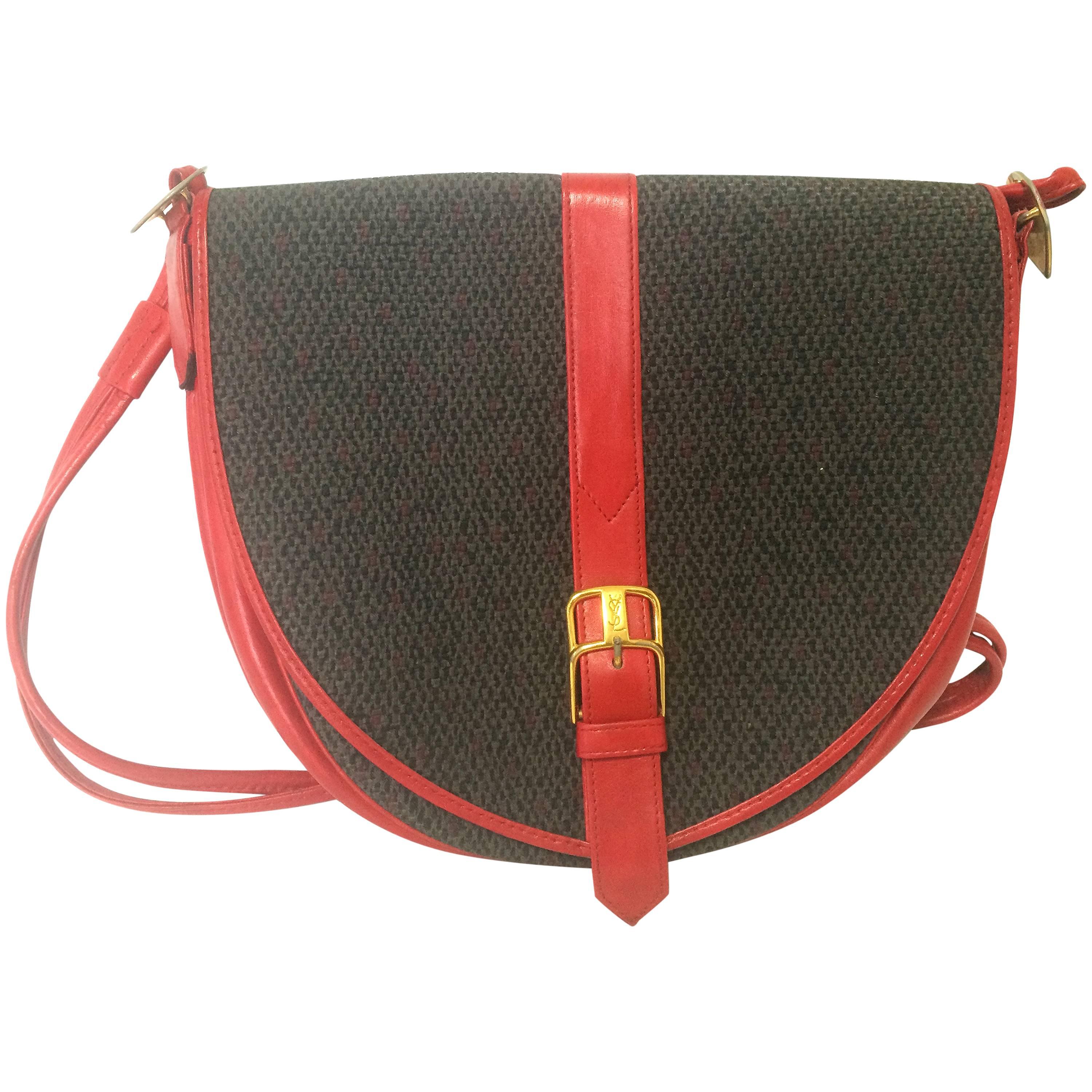 Vintage Yves Saint Laurent oval navy shoulder bag with red shoulder straps. For Sale