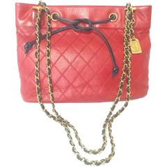 Vintage CHANEL classic tote bag in red leather with golden chain and navy straps