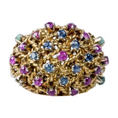 Ring in 18 carat yellow gold with a dome shape with semi-precious stones