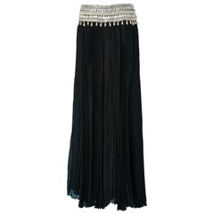 Long black pleated skirt with mother-of-shell buttons waist Alexander McQueen 