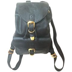 Vintage Gianni Versace black leather backpack with a big embossed medusa mark.