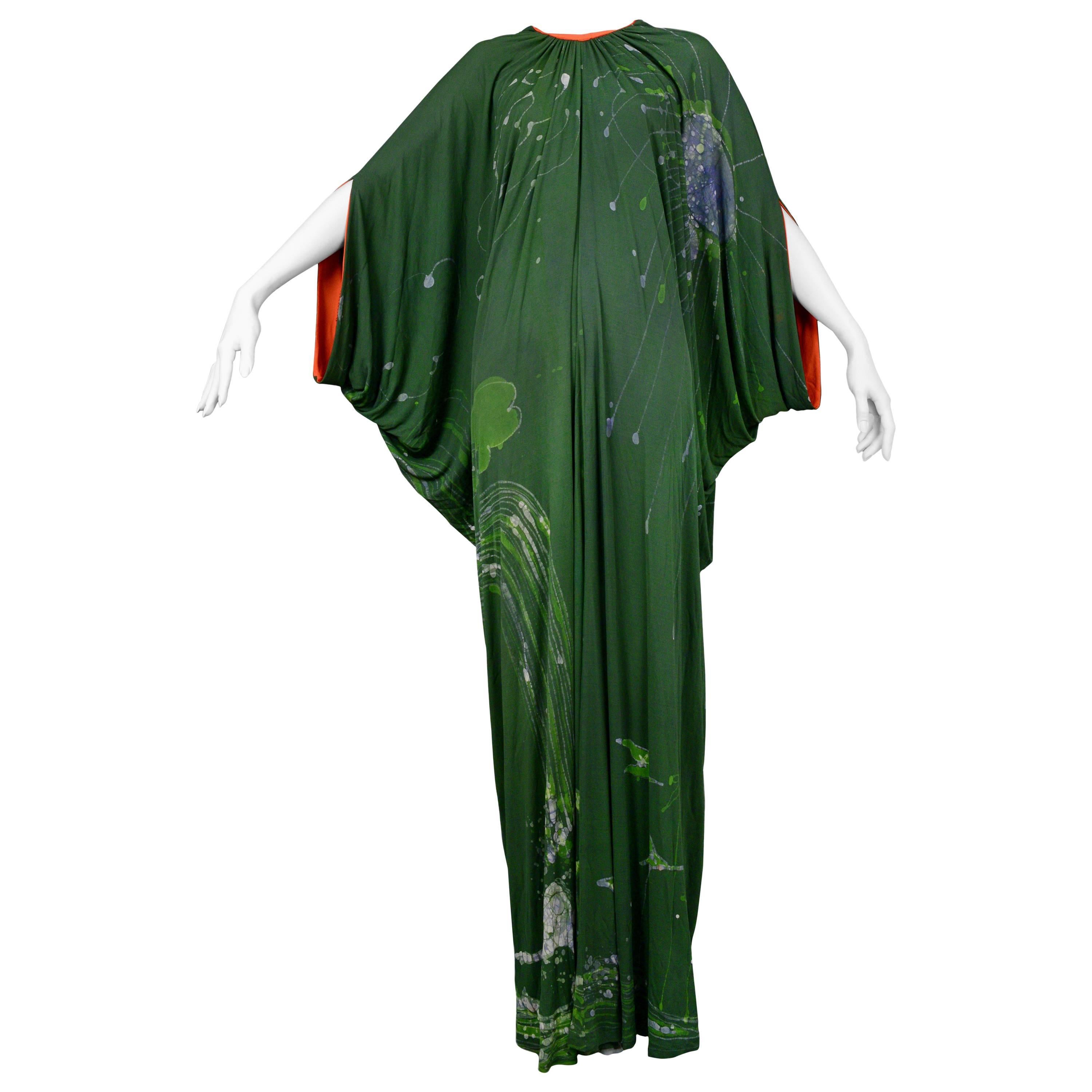 Vintage Yuki London forest green island theme batik heavily draped caftan with bright orange trim.
Please inquire for additional images.