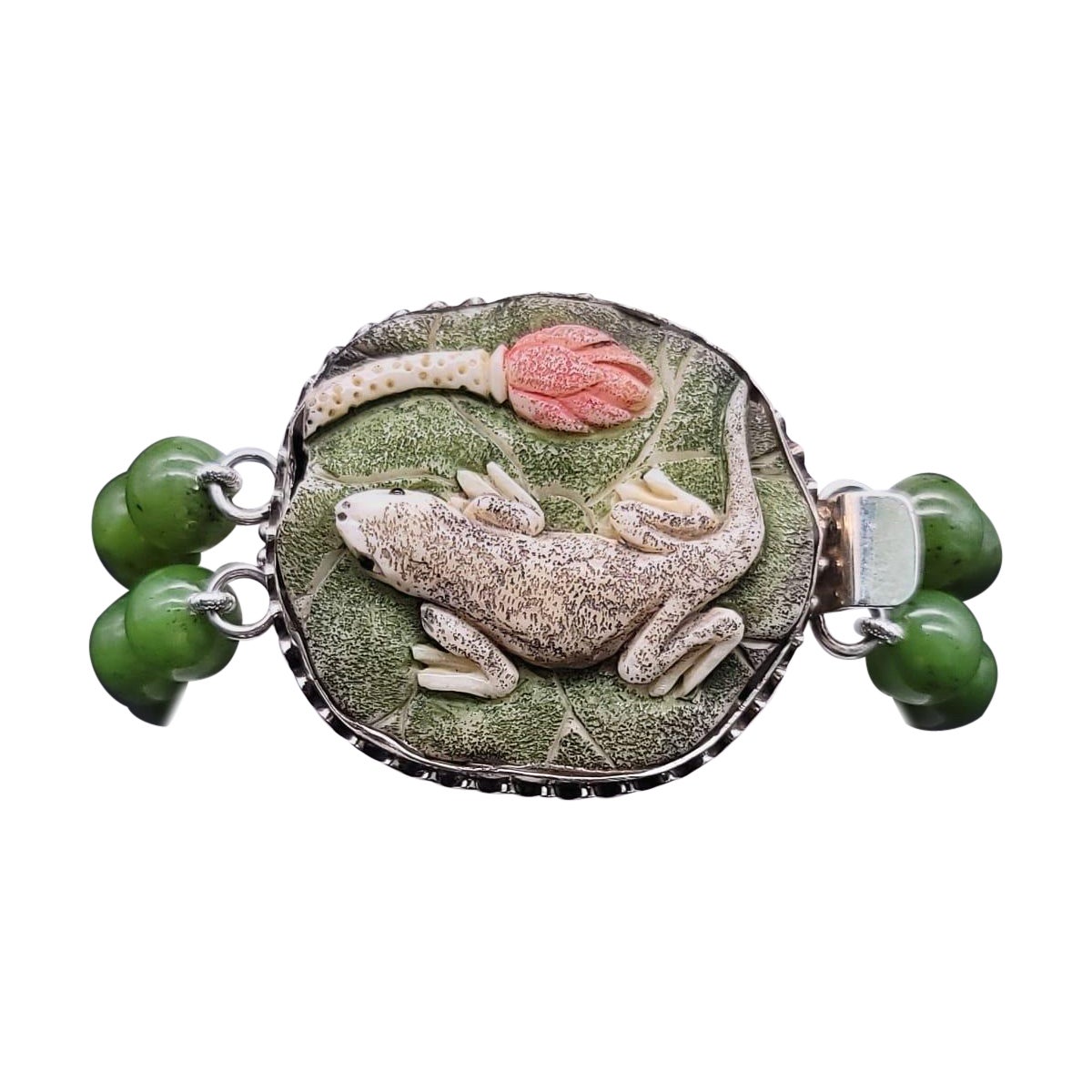 One-of-Kind

A 2-strand stunning jade bead (8m.m) bracelet with a dramatic clasp featuring a large carved, hand-tinted frog on a lotus leaf set in sterling silver, and the lovely rich jade is easy on the eye.

(It also has several symbolic meanings
