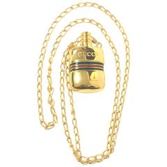 Vintage Gucci golden mini bottle necklace with embossed logo mark and webbing