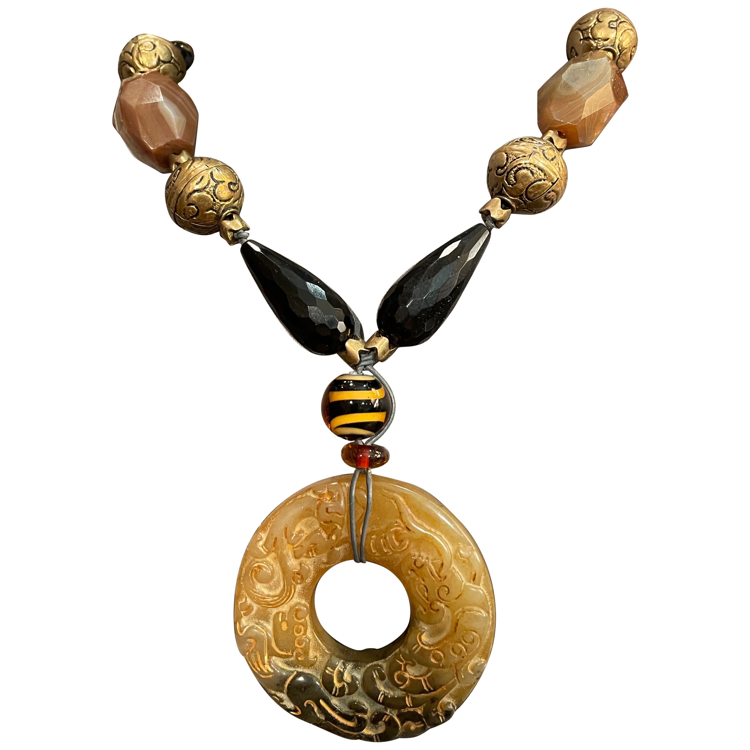 LB Jadeite carved donut pendant necklace with vintage jet, agate, brass and glas For Sale