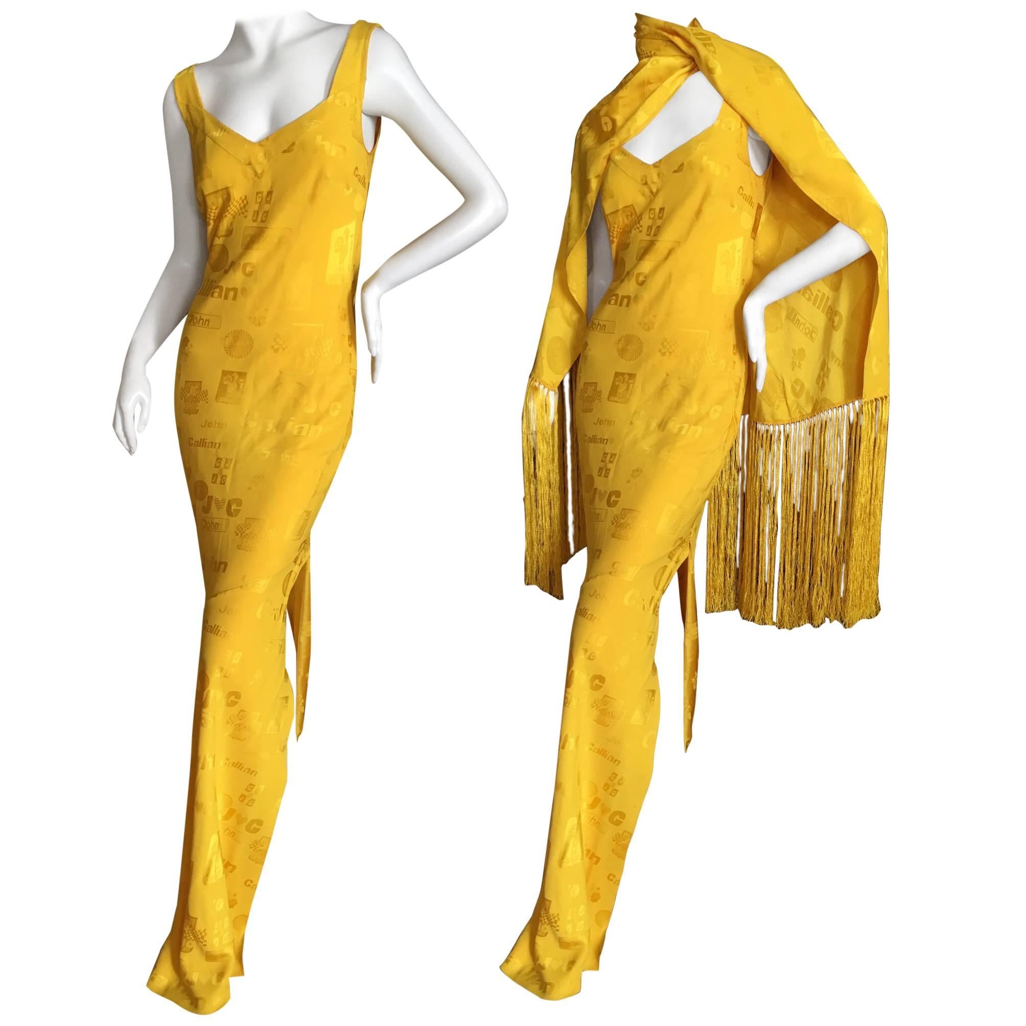 Brilliant yellow bias cut long dress and matching shawl from John Galliano circa 1996.
The Galliano logo's were inspired by classic Nascar logo's.
There is a high side slit.
Size 42
Bust 39