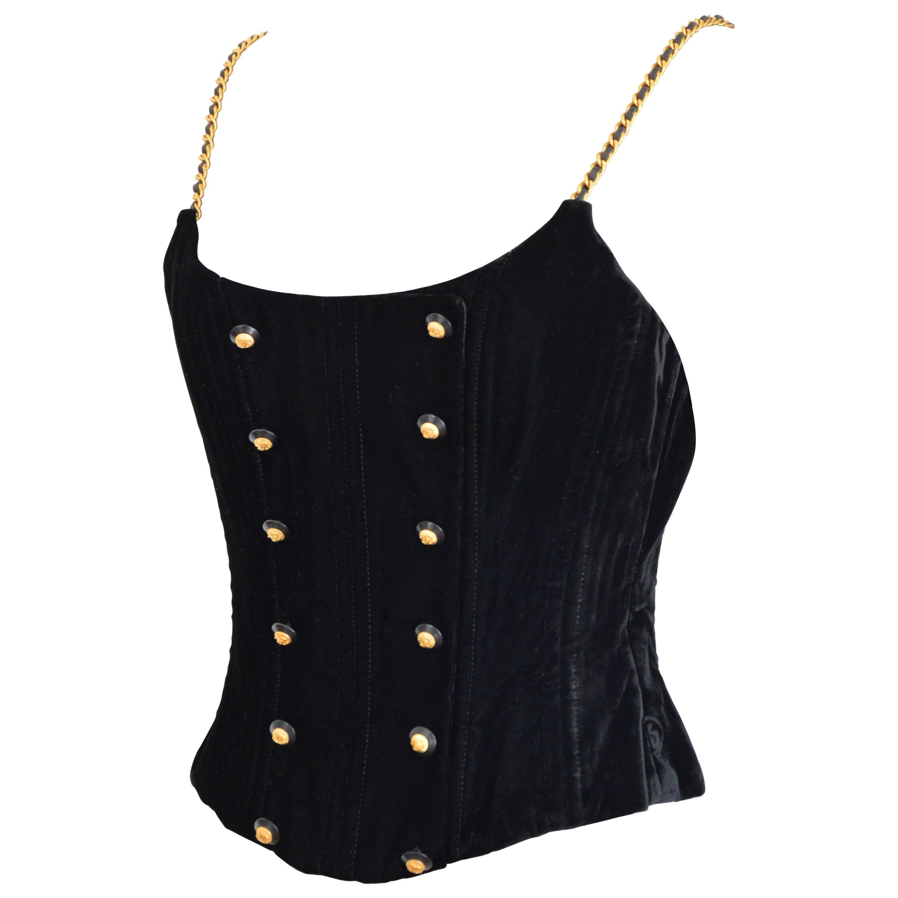 Very cool and still classic with this Chanel made of black velvet, chanel logo buttons, gourmette and black leather shoulder straps. 
Fr size /36 but will fit also a 38 - corresponds to a XS-S.
Excellent condition. Chanel corset of 1993.