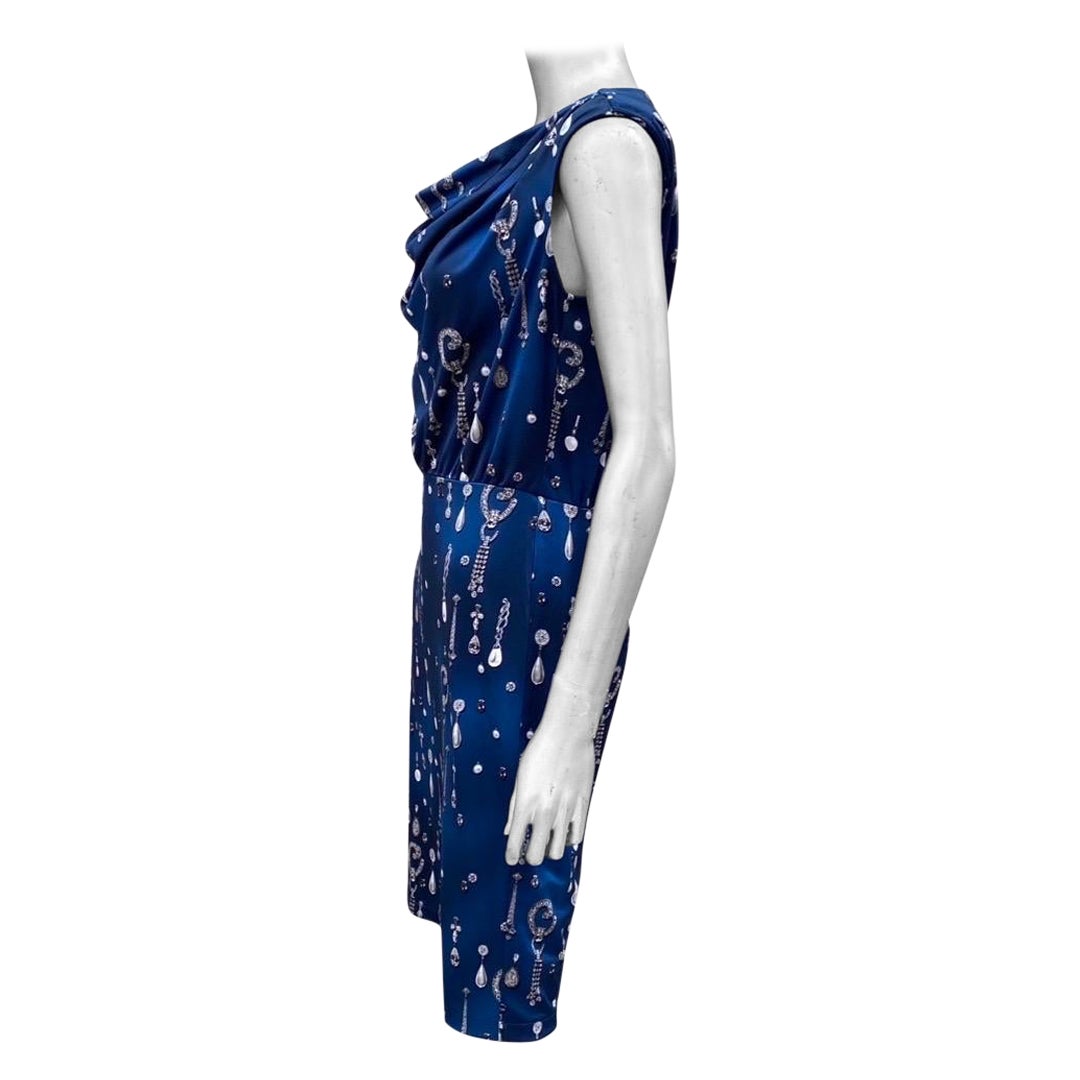 A lovely chic little dress designed by Carmen Marc Valvo for the Carmen label. What makes this dress special is the color and the print. The fabric drapes beautifully on a beautifully Cowl drape front neckline. The print is one of the prettiest and