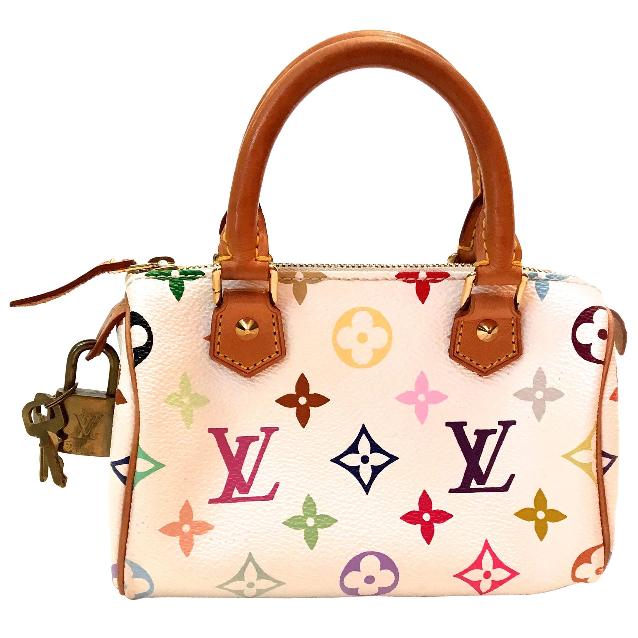 Presented here is a Mini Keepall from Louis Vuitton with a shoulder strap. This particular Mini Keepall is a discontinued style and extremely difficult to find. It is the standard tan leather with white leather background with the classic iconic
