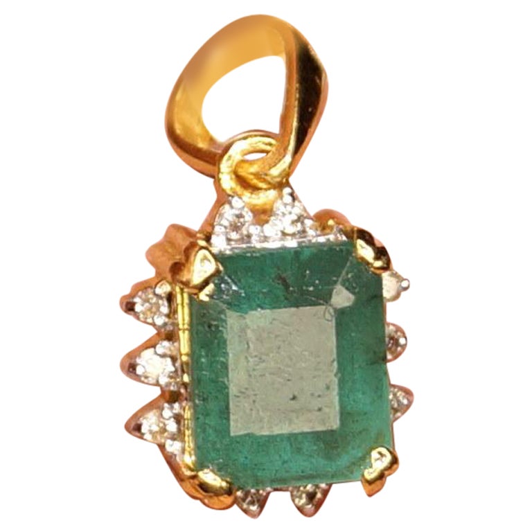 This Stunner Pendant defines class. It completes your everyday look and will also attract special attention on special occasions. This piece of beauty comprises of Natural Zambian Emerald studded in 18K Yellow Gold with excellent diamonds to add