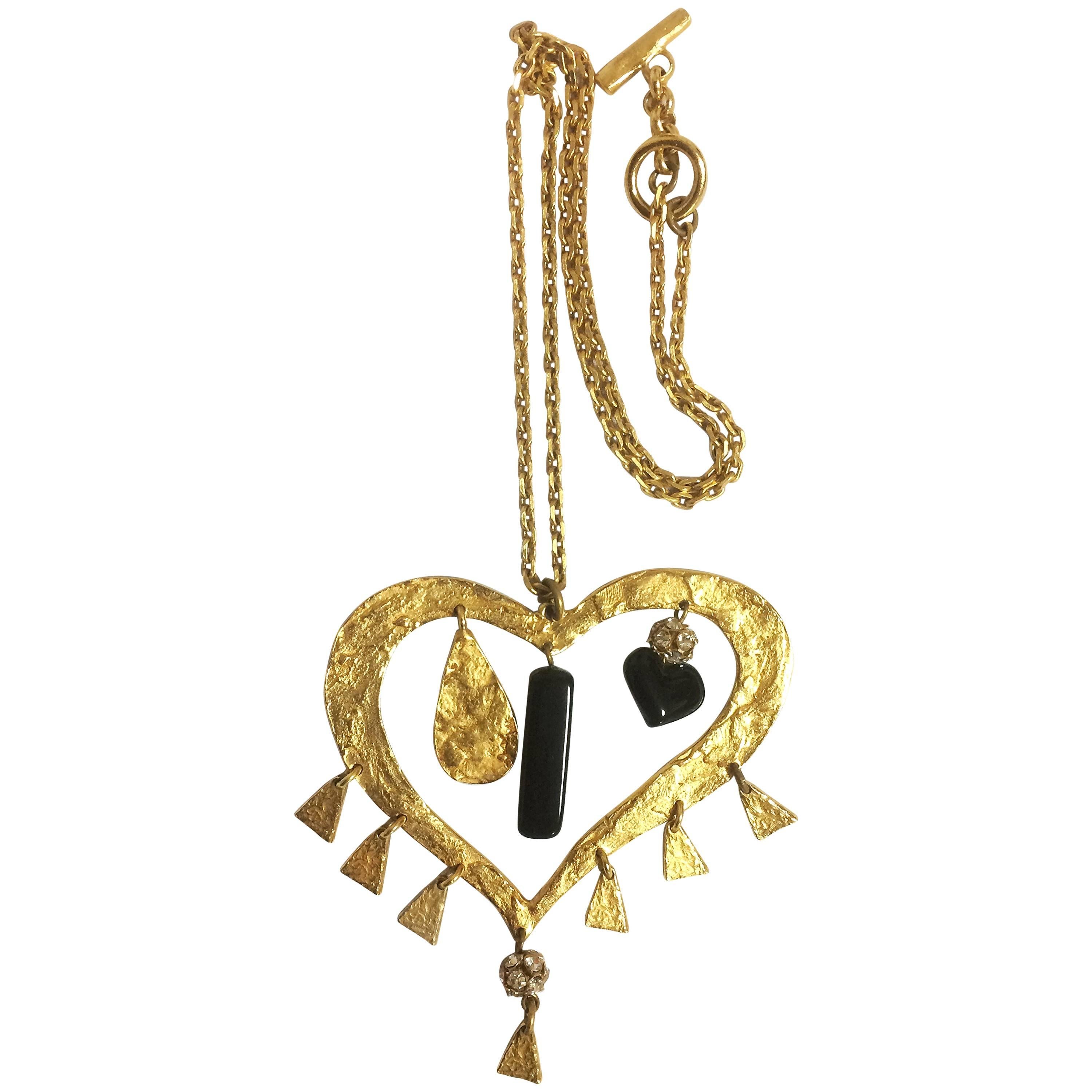 Vintage Christian Lacroix golden large heart necklace with dangling charms. For Sale