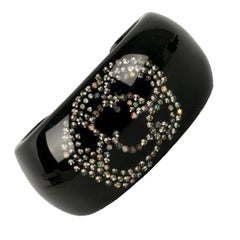 Chanel Cuff Bracelet in Black Bakelite and Rhinestone Camellia