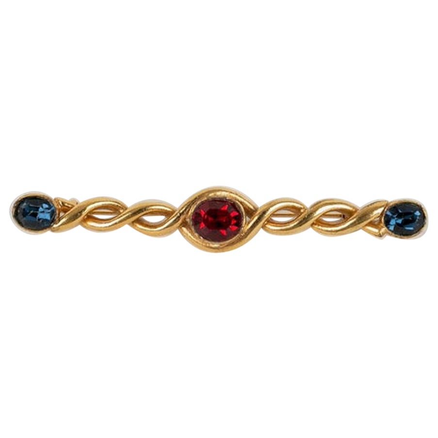 Yves Saint Laurent Gold Metal Brooch with Red and Blue Rhinestones For Sale