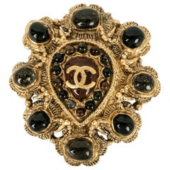 Chanel Brooch in Gold-Plated Metal and Resin