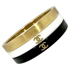 Vintage Chanel Bangle Set of 3: In Gold Tone, White, & Black Resin With CC Logo 
