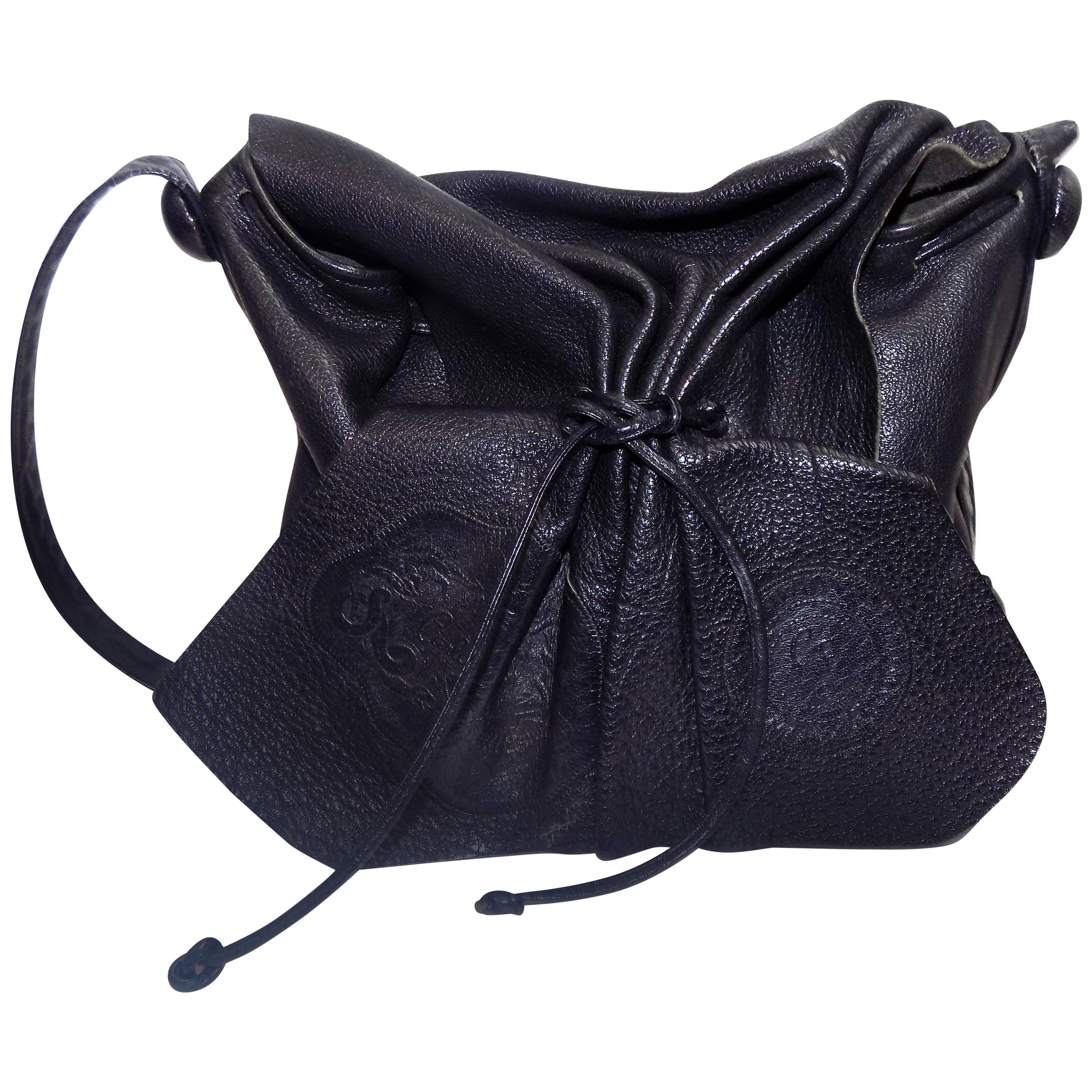 Carlos Falchi's signature black cross-body drawstring large bag