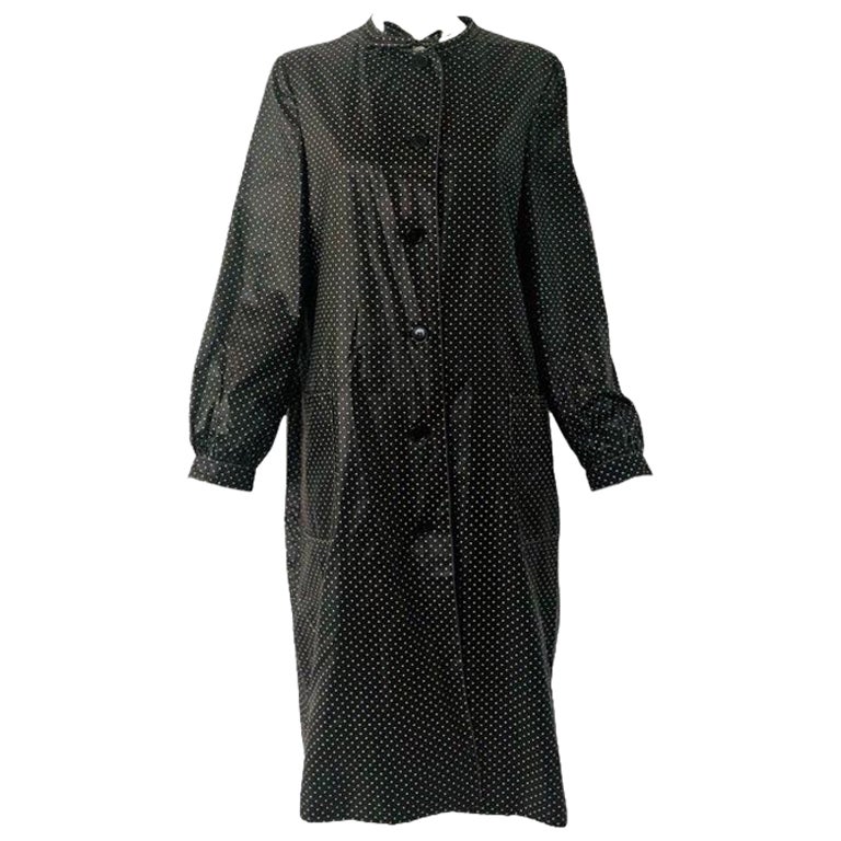 Stunning polka dot trench coat, I believe from the 70s.  Label says 'Bill Blass for Bond Street' and another label which shows it was purchased from Nordstrom.  Very light weight and in excellent condition. Button down the front and a short tie at