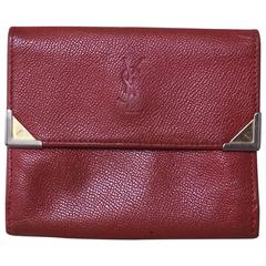 Vintage Yves Saint Laurent red leather wallet with YSL logo embossed motif