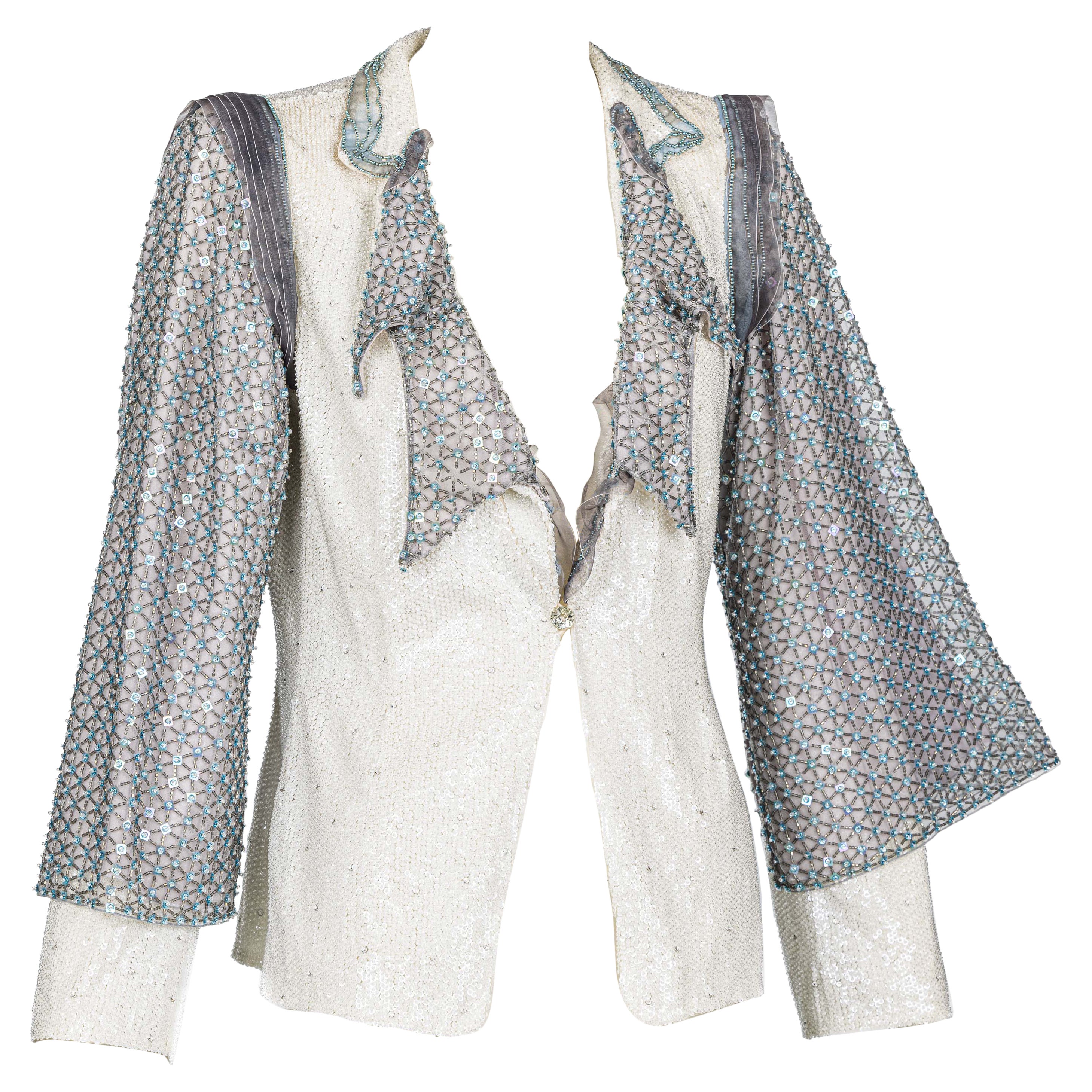 An exceptional Giorgio Armani jacket that was purchased for over $12k.
Completely embellished with sequins and crystals, intricate details with organza layers, and layered beaded sleeves. An absolute showstopper.
The jacket is lined and closes with